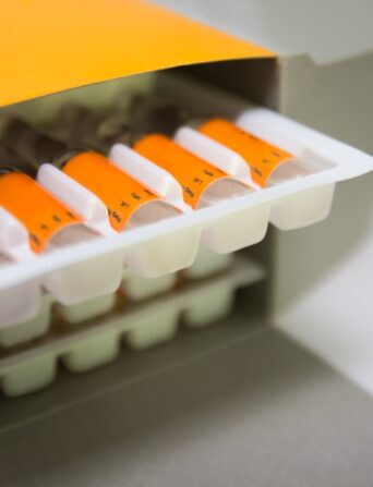An orange box containing medical vials.