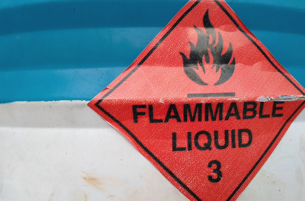 The label of Dangerous Goods Class 3, which is flammable, is attached to the liquid fuel drum.