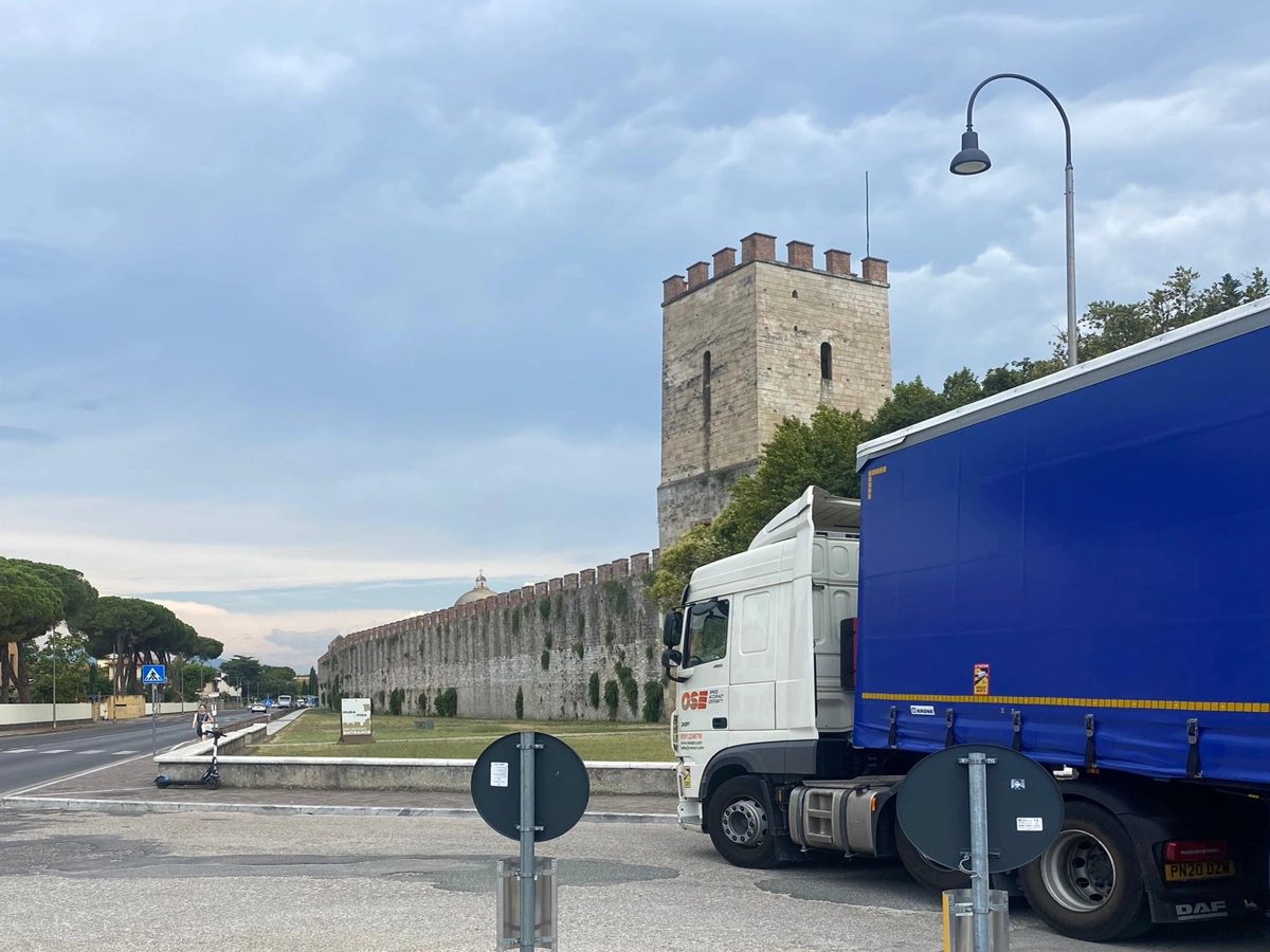 OSE Logistics HGV lorry parked on a road in front of a castle.