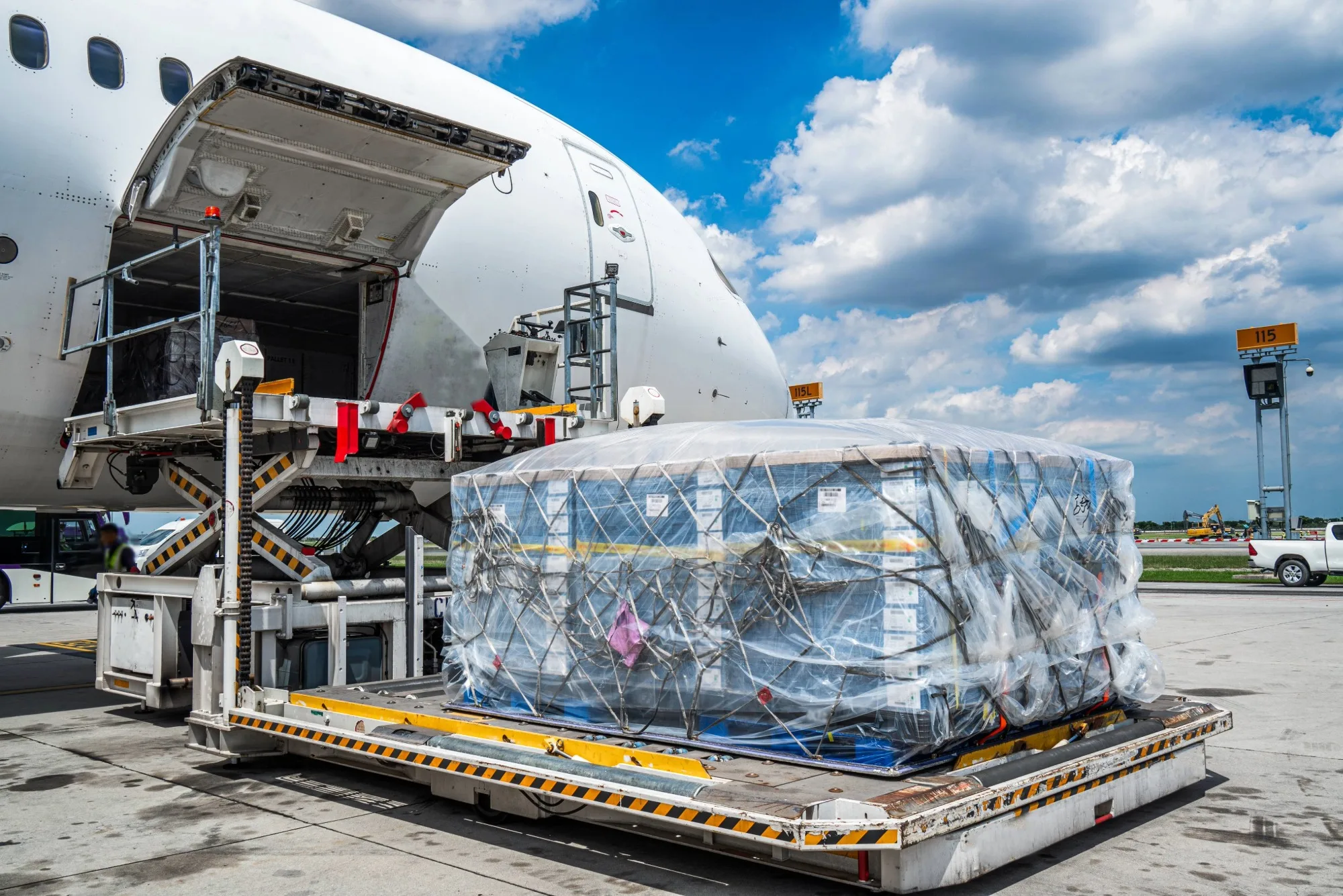 A large pallet of sensitive cargo being loaded onto a plane via a lift.